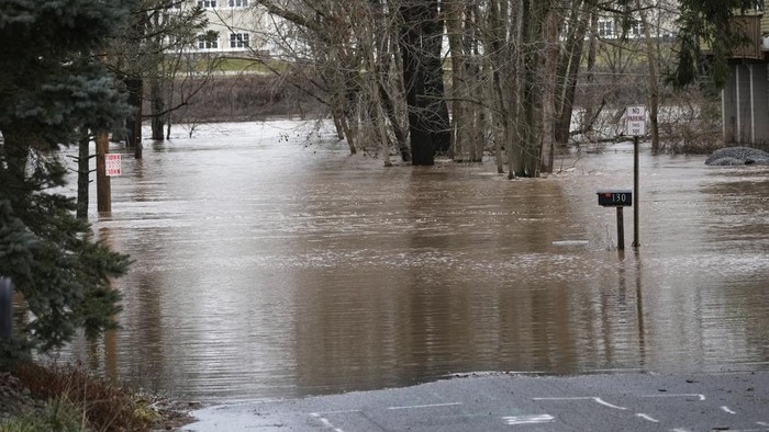 Floodwaters from the Perkiomen Creek submerge a road in Collegeville, Pa., Monday, Dec. 18, 2023. (AP Photo/Matt Rourke)