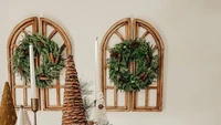 Agar suasana semakin ramai, kamu bisa menaruh berbagai dekorasi pohon natal di ruang tamu. Tak lupa juga menggantungkan rangkaian bunga di dinding agar suasana natal lebih terasa. Foto: Homestead City Dwelling via The Spruce