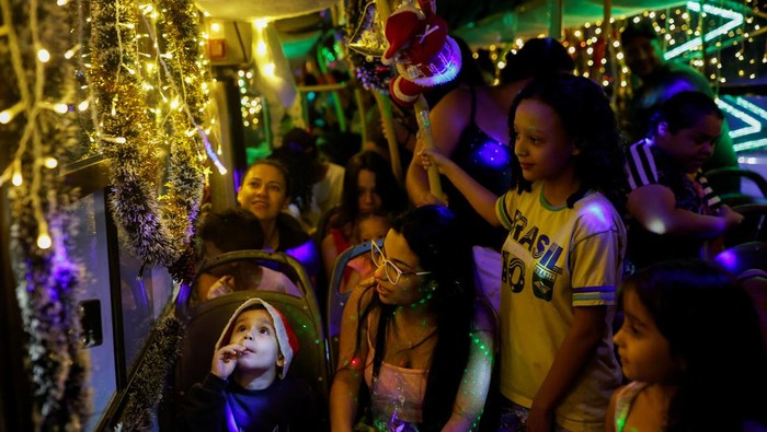 Councilman Edilson Santos, dressed as Santa Claus, poses for a picture outside the 'Bus Noel', a bus decorated by him and his family with Christmas ornaments in Santo Andre, Brazil December 19, 2023. REUTERS/Amanda Perobelli