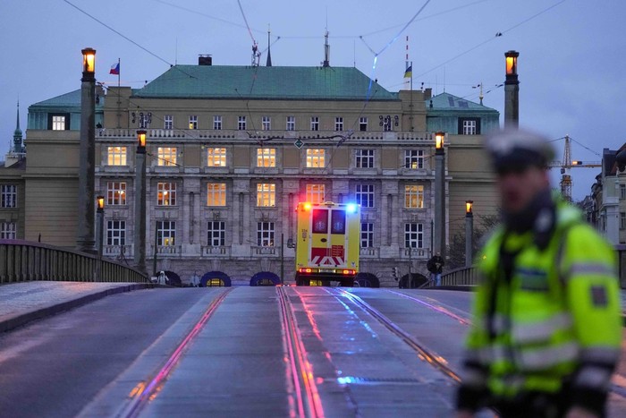 Police officers stand on the balcony of Philosophical Faculty of Charles University in downtown Prague, Czech Republic, Thursday, Dec. 21, 2023. Czech police say a shooting in downtown Prague has killed an unspecified number of people and wounded others. (AP Photo/Petr David Josek)
