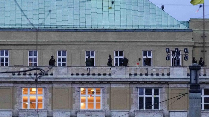Police officers stand on the balcony of Philosophical Faculty of Charles University in downtown Prague, Czech Republic, Thursday, Dec. 21, 2023. Czech police say a shooting in downtown Prague has killed an unspecified number of people and wounded others. (AP Photo/Petr David Josek)