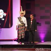 Debat kedua yang digelar khusus untuk cawapres, paslon nomor urut 3 ini bersolek dengan busana daerah. Ganjar yang pernah menjabat sebagai Gubernur Jawa Tengah memakai kemeja putih lengkap dengan kain rote dari Nusa Tenggara Timur (NTT), lengkap dengan topi tiilangga. (Foto: Andhika Prasetia/detikcom)