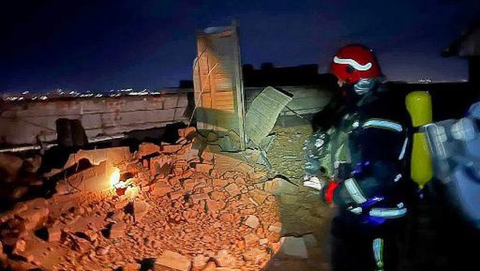 This handout photograph taken and released by Ukrainian Emergency Service on December 22, 2023, shows rescuers working in a damaged multi-storey residential building, after a Russian drone attack in Kyiv. A Russian drone attack hit a residential building and injured at least two people in Kyiv on Deccember 22, 2023 authorities said, in a rare breach of the Ukrainian capitals air defences. (Photo by Handout / UKRAINIAN EMERGENCY SERVICE / AFP) / - NO Editorial use - NO Marketing campaign / -----EDITORS NOTE --- RESTRICTED TO EDITORIAL USE - MANDATORY CREDIT AFP PHOTO / HANDOUT/Ukrainian Emergency Service  - NO MARKETING - NO ADVERTISING CAMPAIGNS - DISTRIBUTED AS A SERVICE TO CLIENTS