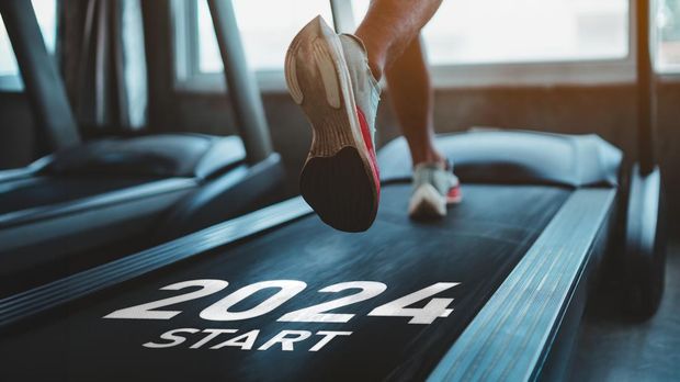 Happy new year 2024,2024 symbolizes the start of the new year. Close up of feet, sportsman runner running on treadmill in fitness club. Cardio workout. Healthy lifestyle, guy training in gym.