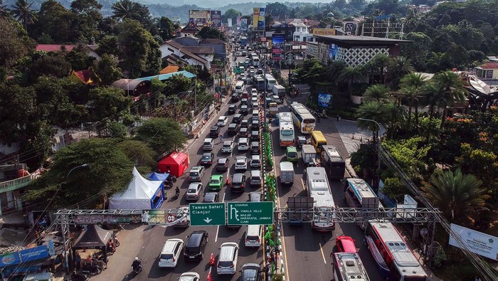 Foto udara kepadatan kendaraaan saat diberlakukan sistem satu arah menuju jalur wisata Puncak, Gadog, Kabupaten Bogor, Jawa Barat, Sabtu (23/12/2023). Satlantas Polres Bogor menerapkan rekayasa lalu lintas berupa sistem ganjil genap, sistem lawan arah (contraflow) dan sistem satu arah (one way)  di kawasan wisata Puncak dalam rangka libur panjang Natal 2023 untuk mengantisipasi kepadatan arus kendaraan. ANTARA FOTO/Yulius Satria Wijaya/foc.