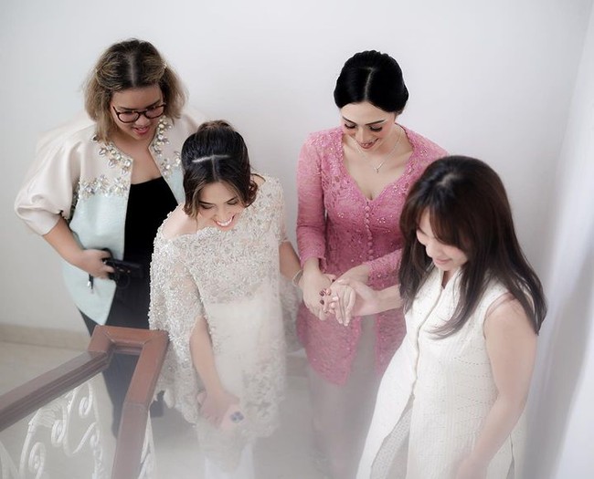 Ririn telah canik mengenakan kebaya pink. Menyesuaikan busana, rambutnya ditata sanggul. Wanita tersebut menerapkan makeup yang flawless dengan lipstik bernuansa pink.  Foto: Instagram @dewiandarini