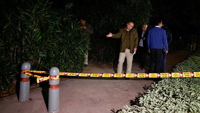 A police officer removes the security tape outside the Israeli embassy, following an investigation on a reported explosion nearby, in New Delhi, India, December 26, 2023. REUTERS/Anushree Fadnavis