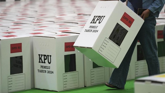 Workers arrange ballot boxes prepared for 2024 election and temporary stored at a stadium in Jakarta, Indonesia, Tuesday, Dec. 26, 2023. The worlds third-largest democracy is gearing up to hold its legislative and presidential elections on Feb. 14, 2024. (AP Photo/Tatan Syuflana)
