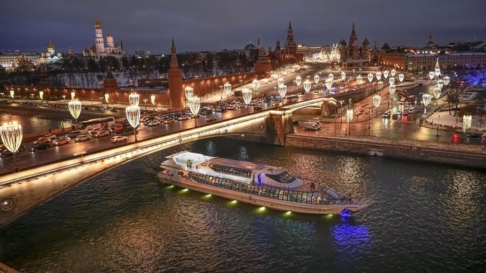 The Spasskaya Tower, Red Square, the GUM department store, and the St. Basil's Cathedral decorated for the New Year and Christmas festivities are seen through a window of the Hotel Baltschug Kempinski Moscow in Moscow, Russia, on Tuesday, Dec. 26, 2023. (AP Photo/Alexander Zemlianichenko)