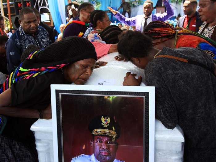 Arak-arakan warga saat membawa peti jenazah mantan Gubernur Papua Lukas Enembe ke tempat persemayaman di Koya Tenga, Kota Jayapura, Papua, Kamis (28/12/2023). Peristiwa tersebut diwarnai kericuhan yaitu massa membakar mobil dan menyerang aparat. ANTARA FOTO/Gusti Tanati