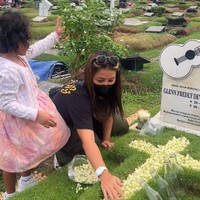 Gewa juga ikut memberikan bunga melati ke atas makam yang dibantu Mutia Ayu. Mutia Ayu terlihat mengenakan baju kasual berupa kaos hitam dan celana cargo. Foto: Instagram @mutia_ayuu