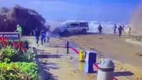 Tampak wisatawan berlari menjauhi garis pantai saat air naik ke permukaan.