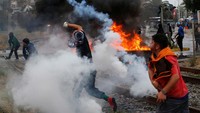Aksi ini berlangsung ricuh saat demonstran membakar ban.  
