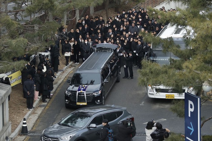 Mourners carry a portrait and the casket containing late South Korean actor Lee Sun-kyun after his funeral ceremony at the Seoul National University Hospital in Seoul on December 29, 2023. The late South Korean actor Lee Sun-kyun's body was transported from the funeral home to a crematorium in a private ceremony on December 29, with his death raising questions about alleged harsh police practices and media sensationalism. (Photo by KOREA POOL / AFP)