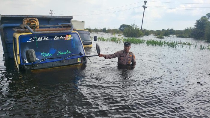 Mobil truk yang mogok dan terjebak banjir di Pelalawan. (Dok Polsek Langgam)