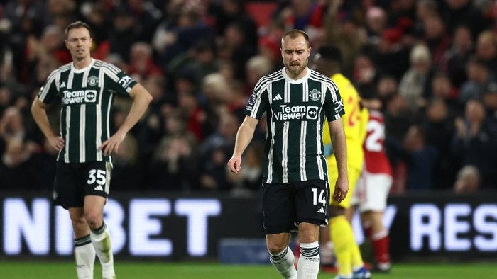Manchester United Northern Irish defender #35 Jonny Evans (L) and Manchester Uniteds Danish midfielder #14 Christian Eriksen (R) react after conceding the first goal during the English Premier League football match between Nottingham Forest and Manchester United at The City Ground in Nottingham, central England, on December 30, 2023. (Photo by Darren Staples / AFP) / RESTRICTED TO EDITORIAL USE. No use with unauthorized audio, video, data, fixture lists, club/league logos or live services. Online in-match use limited to 120 images. An additional 40 images may be used in extra time. No video emulation. Social media in-match use limited to 120 images. An additional 40 images may be used in extra time. No use in betting publications, games or single club/league/player publications. /