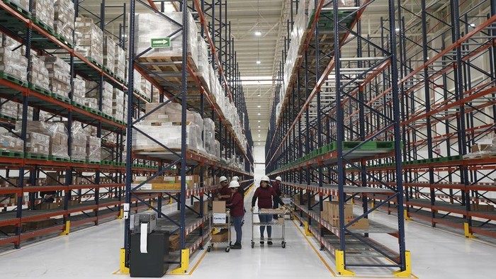 Workers stand inside a 