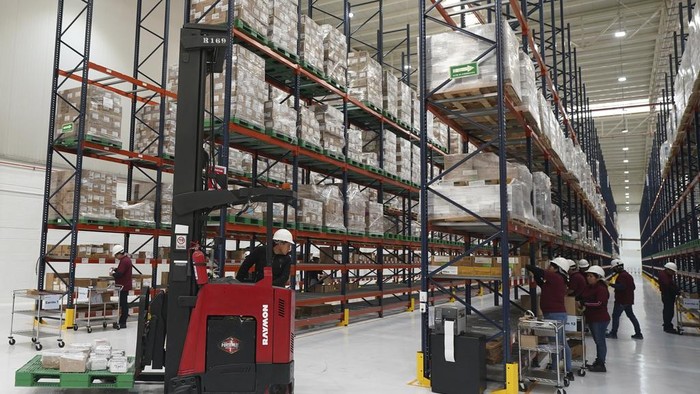 Workers stand inside a 