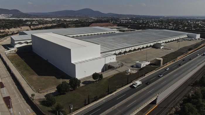 Workers stand inside a 