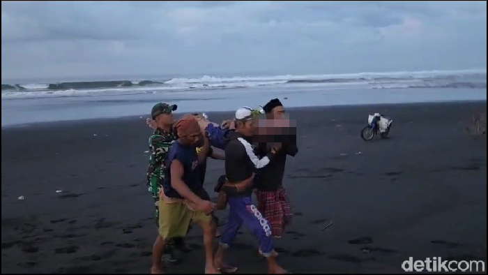 Proses evakuasi nelayan tewas terseret ombak di pantai Lumajang.