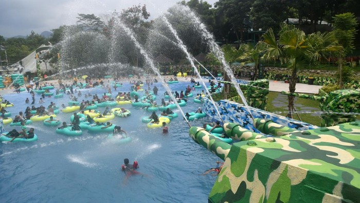 Sejumlah pengunjung bermain air di wahana kolam ombak Basecamp Military Lifestyle, Bogor, Jawa Barat, Minggu (31/12/2023). Wisata air dengan nuansa militer di kawasan Puncak, Bogor tersebut telah dikunjungi sekitar 4 ribu orang pengunjung selama libur Natal dan Tahun Baru 2024. ANTARA FOTO/Arif Firmansyah/nym.