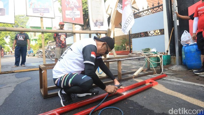 Ketua DPC PDIP Solo FX Hadi Rudyatmo, saat mengelas portal di Kelurahan Pajang, Kecamatan Laweyan, Kota Solo, Senin (1/1/2024).