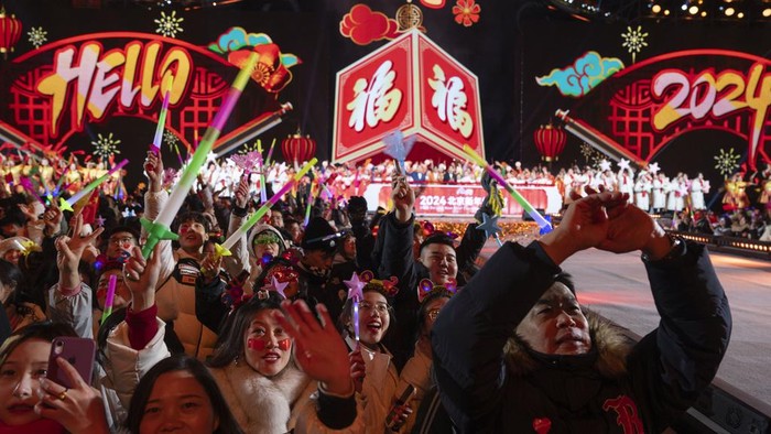 Revelers ring in the new year after a countdown to 2024 in Beijing, Monday, Jan. 1, 2024. (AP Photo/Ng Han Guan)