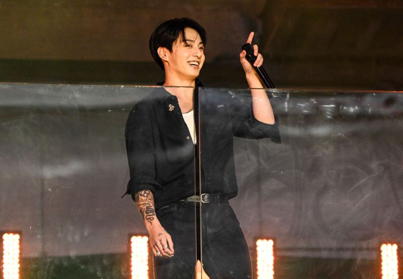 Jung Kook performs during a surprise concert in Times Square on November 9, 2023 in New York City. (Photo by Daniel Zuchnik/Billboard via Getty Images)