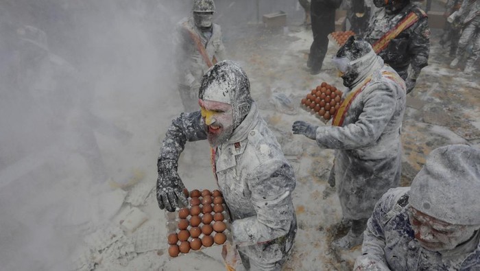 Revellers battle with flour and eggs during the traditional 