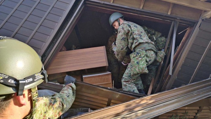 Japanese Self-Defense Force soldiers conduct rescue operations at a collapsed house caused by an earthquake in Wajima, Ishikawa prefecture, Japan January 2, 2024, in this handout photo released by the Joint Staff Office of the Defense Ministry of Japan. Joint Staff Office of the Defense Ministry of Japan/HANDOUT via REUTERS ATTENTION EDITORS - THIS IMAGE WAS PROVIDED BY A THIRD PARTY.  MANDATORY CREDIT.