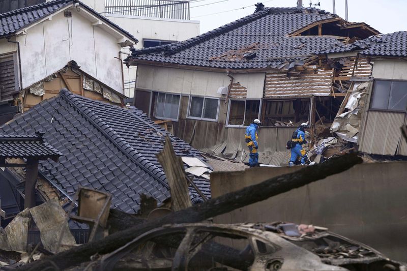 Police officers search missing people at a collapsed house caused by an earthquake in Wajima, Ishikawa prefecture, Japan January 2, 2024, in this photo released by Kyodo. Mandatory credit Kyodo/via REUTERS   ATTENTION EDITORS - THIS IMAGE HAS BEEN SUPPLIED BY A THIRD PARTY. MANDATORY CREDIT. JAPAN OUT. NO COMMERCIAL OR EDITORIAL SALES IN JAPAN.