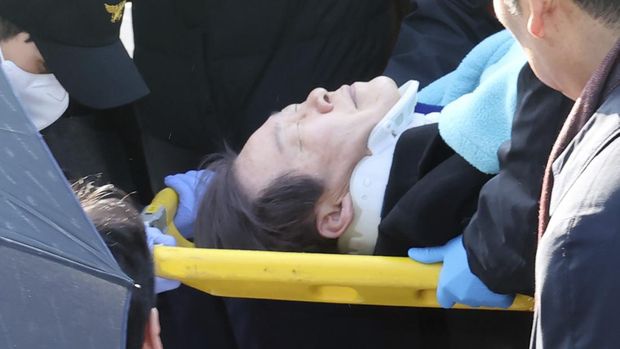 South Korean opposition leader Lee Jae-myung on a stretcher, is carried by rescue team in Busan, South Korea, Tuesday, Jan. 2, 2024. Lee was attacked and injured by an unidentified man during a visit Tuesday to the southeastern city of Busan, emergency officials said. (Ha Kyung-min/Newsis via AP)