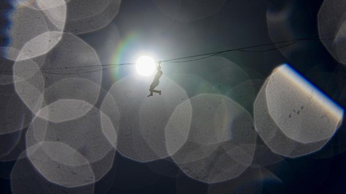 French highliner Nathan Paulin walks a slackline over Bernardo O'Higgins Avenue in Santiago, Chile, Wednesday, Jan. 3, 2024. Paulin's tightrope performance kicks off the 