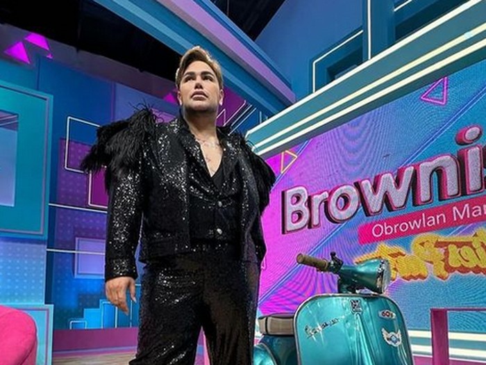 Two creations for the beach by the Angelo Litrico fashion house of Rome, Nov. 3, 1969, to be presented at the Florence show of Italian spring-summer 1970 high fashion ready-to-wear boutique collections, opening on November 3. For the man: An evening dress fir the beach of blue jersey, consisting of a sort of overall with very wide legged trousers, laced along the front and worn with a small jacket and a large gilded bracelet. For the Woman: An after the sea beach dress of silk shantung printed on ivory ground, with pockets and a scarf tied around the waist. (AP Photo/Mario Torrisi)