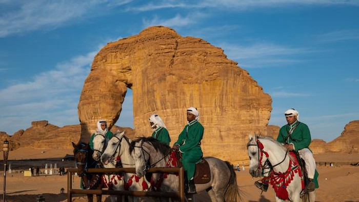 Buses are parked at different places in the desert to take tourists to different places during the day in Al-Ula, Saudi Arabia.