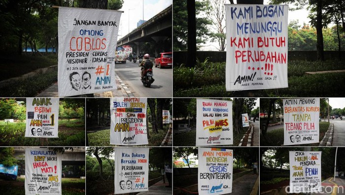Deretan Spanduk Dukung AMIN Nempel di Pohon Jakarta Utara Sejumlah warga melintas di sekitar spanduk dukungan paslon capres cawapres Anies Baswedan-Muhaimin Iskandar (Amin) di sepanjang Jalan Yos Sudarso, Tanjung Priok, Jakarta Utara (5/1/2024).