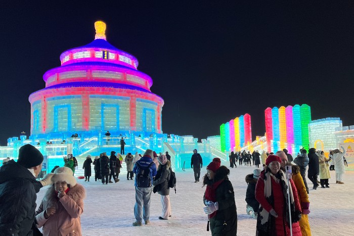 Visitors take pictures near ice sculptures at the Harbin Ice and Snow Festival in Harbin, Heilongjiang province, China December 24, 2023. REUTERS/Liz Lee