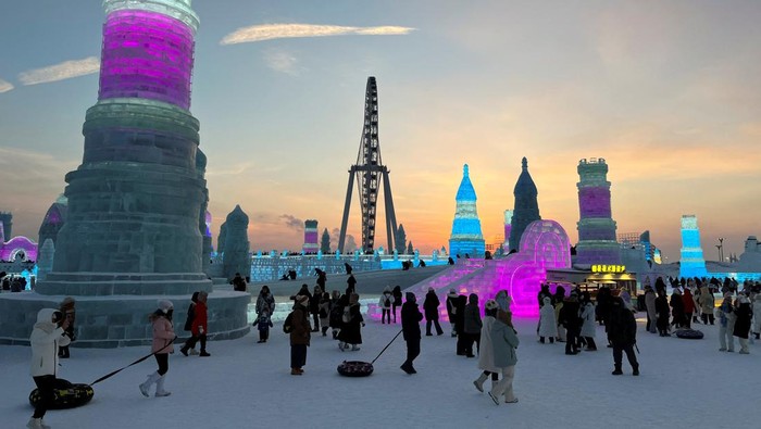 Visitors walk past ice sculptures at the Harbin Ice and Snow Festival in Harbin, Heilongjiang province, China December 24, 2023. REUTERS/Liz Lee