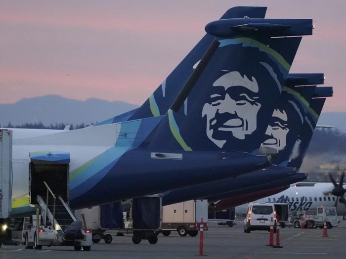 FILE - Alaska Airlines planes are shown parked at gates at sunrise, March 1, 2021, at Seattle-Tacoma International Airport in Seattle. An Alaska Airlines flight made an emergency landing in Oregon on Friday, Jan. 5, 2024, after a window and chunk of its fuselage blew out in mid-air, media reports said. (AP Photo/Ted S. Warren, File)