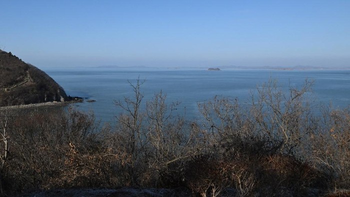 A general view shows the North Korean coastline (top) as seen from a viewpoint on Yeonpyeong island, near the northern limit line sea boundary with North Korea, on January 6, 2024. North Koreas military fired over 60 artillery rounds near Yeonpyeong Island on January 6, Seouls military said, a day after both sides staged live-fire drills in the same area, near their contested maritime border. (Photo by Jung Yeon-je / AFP)