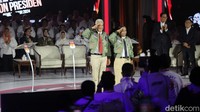 Ganjar-Mahfud mengenakan jaket bomber dengan kemeja putih dan dasi merah.