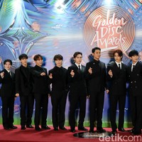 11 personel Seventeen kompak memberikan love sign saat berpose di red carpet Golden Disc Awards 2024. Foto: Andhika Prasetia/Detikcom