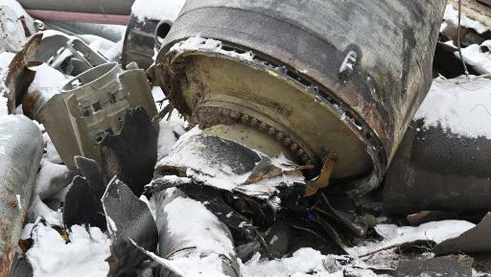 In this photo, taken on January 6, 2024, the remains of a missile used during an attack on Kharkiv on January 2, are covered with snow. (Photo by SERGEY BOBOK / AFP)
