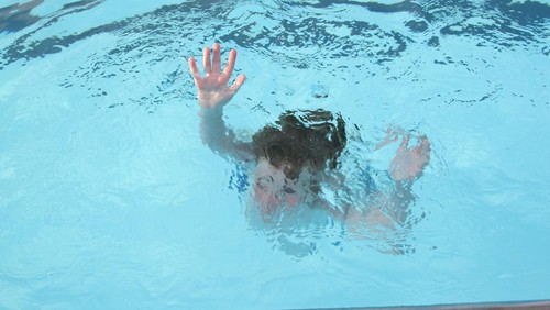Young boy, sinking into the water (no actual children hurt during the making of this photo).