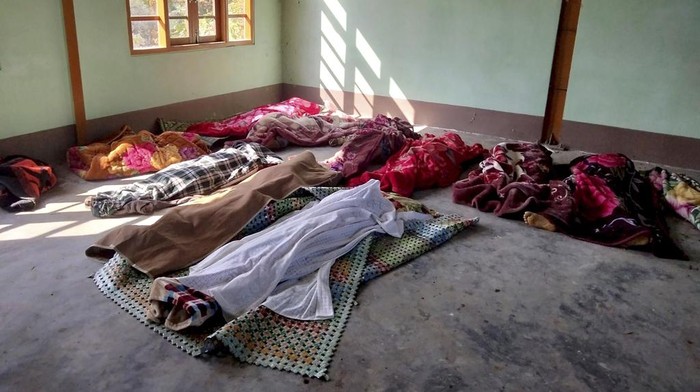People clean the victims of airstrikes being shrouded in blankets at a building in Kanan village, Khampat town in Sagaing region on Sunday, Jan.7, 2024. Airstrikes by Myanmar’s military on a village under the control of the pro-democracy resistance in the country’s northwest are reported to have killed at least 17 civilians, including nine children. (AP Photo)