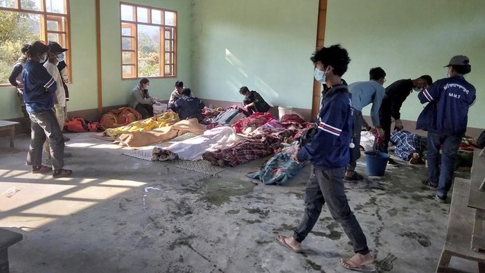 People clean the victims of airstrikes being shrouded in blankets at a building in Kanan village, Khampat town in Sagaing region on Sunday, Jan.7, 2024. Airstrikes by Myanmar’s military on a village under the control of the pro-democracy resistance in the country’s northwest are reported to have killed at least 17 civilians, including nine children. (AP Photo)
