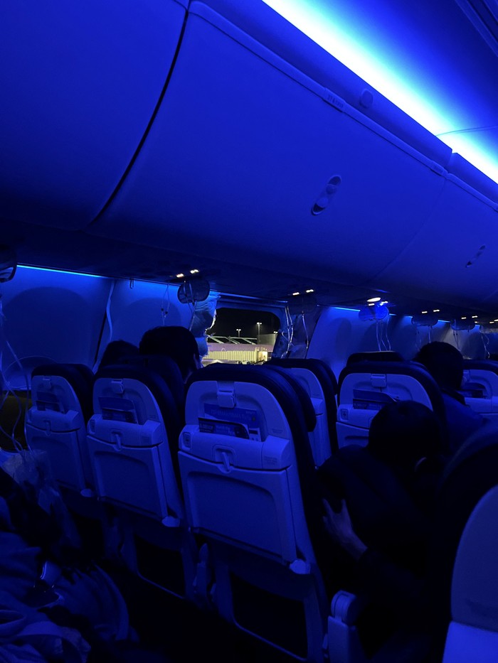 Passenger oxygen masks hang from the roof next to a missing window and a portion of a side wall of an Alaska Airlines Flight 1282, which had been bound for Ontario, California and suffered depressurization soon after departing, in Portland, Oregon, U.S., January 5, 2024 in this picture obtained from social media. Instagram/@strawberrvy via REUTERS  THIS IMAGE HAS BEEN SUPPLIED BY A THIRD PARTY. MANDATORY CREDIT.