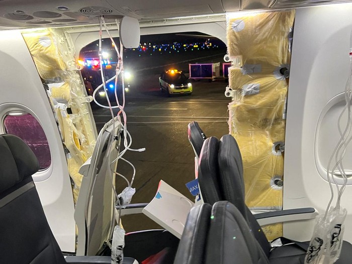 Passenger oxygen masks hang from the roof next to a missing window and a portion of a side wall of an Alaska Airlines Flight 1282, which had been bound for Ontario, California and suffered depressurization soon after departing, in Portland, Oregon, U.S., January 5, 2024 in this picture obtained from social media. Instagram/@strawberrvy via REUTERS  THIS IMAGE HAS BEEN SUPPLIED BY A THIRD PARTY. MANDATORY CREDIT.