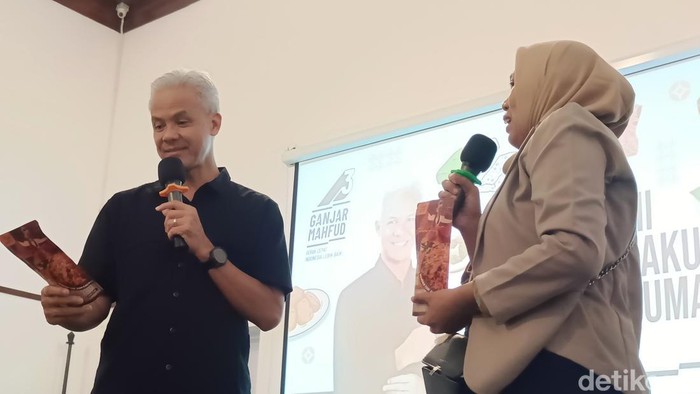 Ganjar Pranowo mendapat jajanan kering kentang mustofa saat bertemu dengan pelaku UMKM Banyumas di Hetero Space Purwokerto, Selasa (9/1/2024).