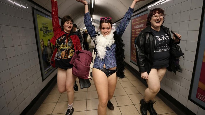 A woman poses as she travels on the London Underground during the 